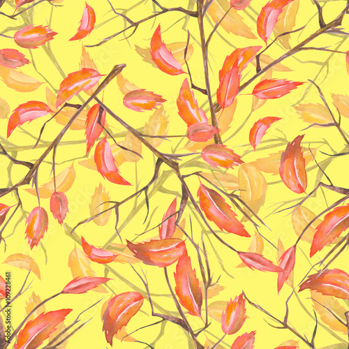 A seamless pattern with a floral ornament of the watercolor red autumn leaves on the branches on a yellow background