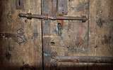 Ancient timber entrance with a lock and a latch