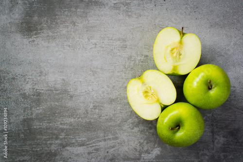 Green apples on concrete background photo