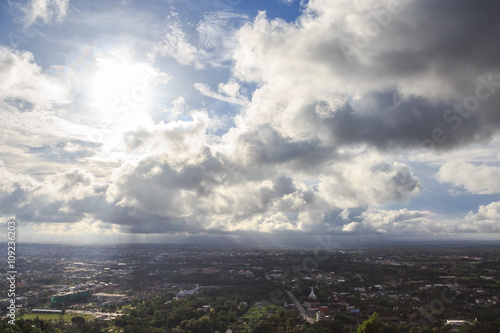 aerial top view of urban city with clouds and sun light reflect