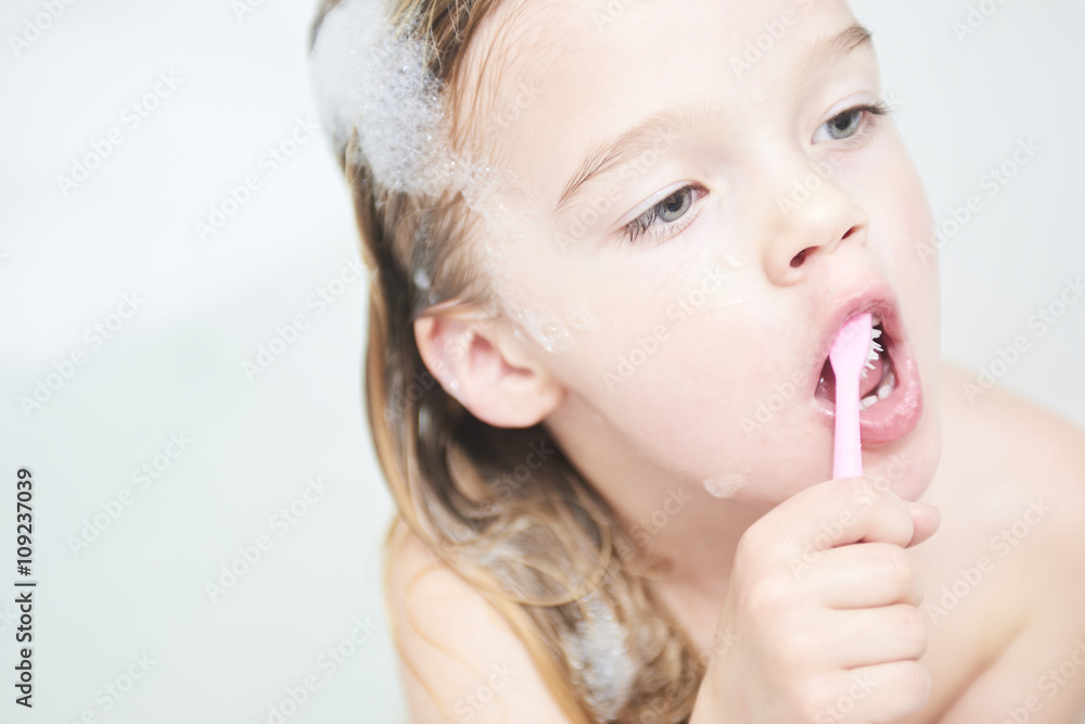 Dental hygiene. Close up of little girl brushing her teeth. Fun in the bath Dental hygiene. Close up of little girl brushing her teeth. Fun in the bath