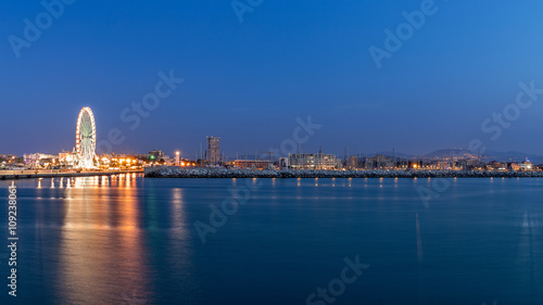 Rimini waterfront cityscape at evening. Urban night lights photo