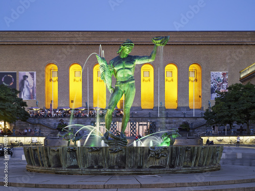 Illuminated fountain at night photo