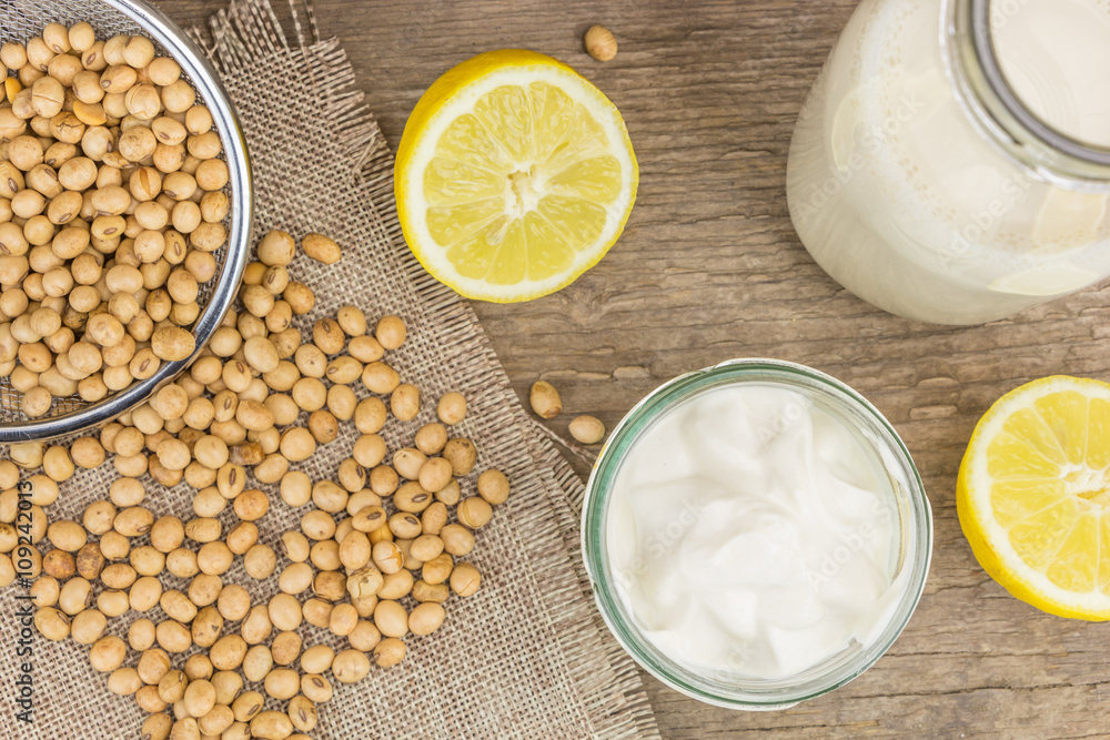 Soy mayonnaise, soy milk, lemon and soybeans, on wooden background Soy mayonnaise, soy milk, lemon and soybeans, on wooden background