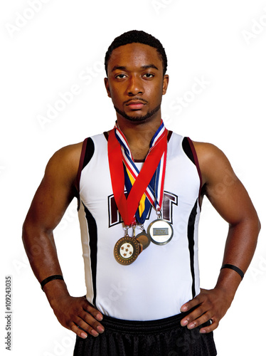 Track player displaying award metals hanging around his neck.  African American male.