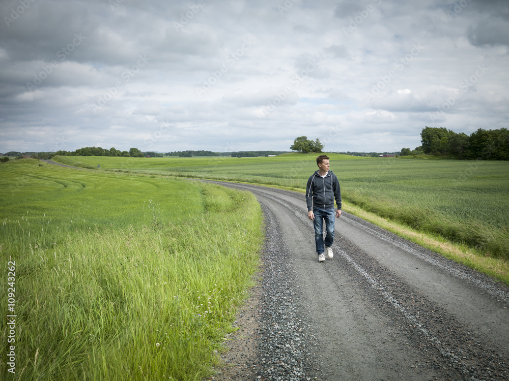 Man walking on dirt track Man walking on dirt track