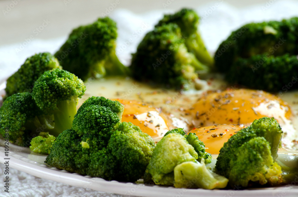 Broccoli and eggs cooked on the plate Broccoli and eggs cooked on the plate