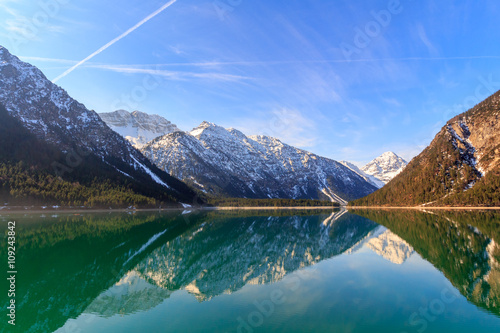 Lake Plansee with mountains reflecting in the water, Tyrol, Austria