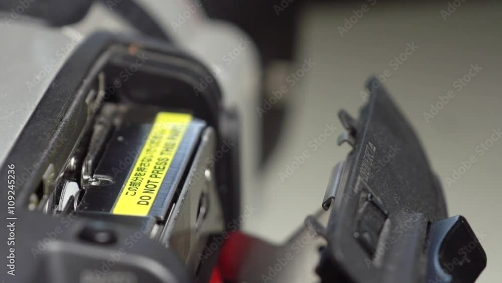 Ejecting a MiniDV tape from a camera deck in extreme slow motion. Stock