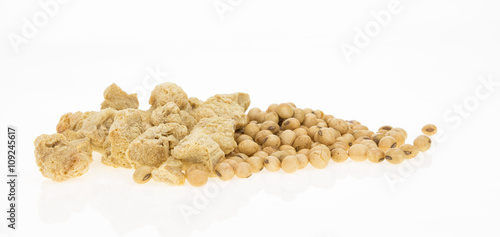 Soybeans and dry soya chunks, isolated on white background.