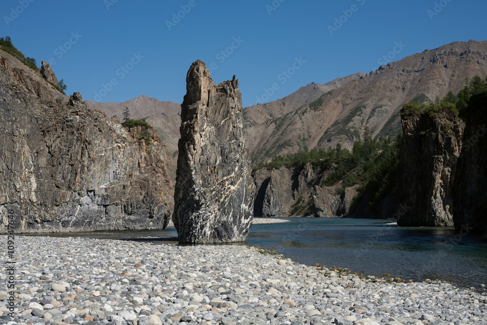 Own a rock in the middle of the riverbed. River Omulevka. Yakutia. Russia.