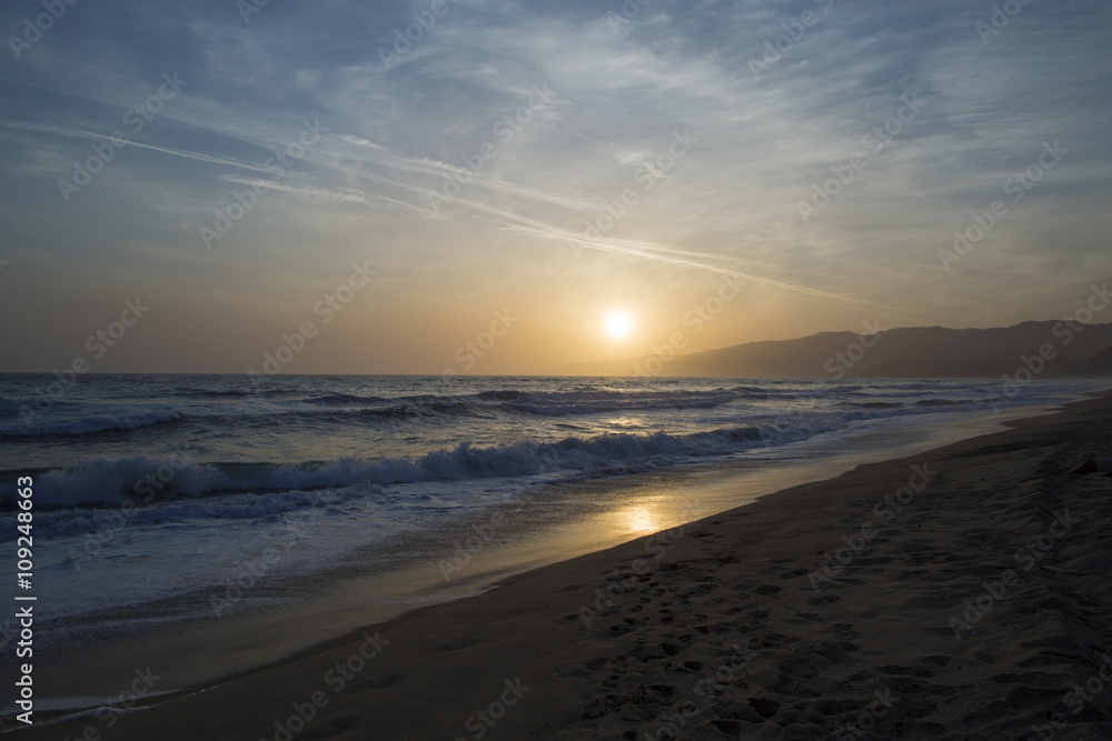 The Pacific ocean during sunset. Landscape with blue sea, the mountains and the dusk sky, the USA, Santa Monica. The Pacific ocean during sunset. Landscape with blue sea, the mountains and the dusk sky, the USA, Santa Monica.
