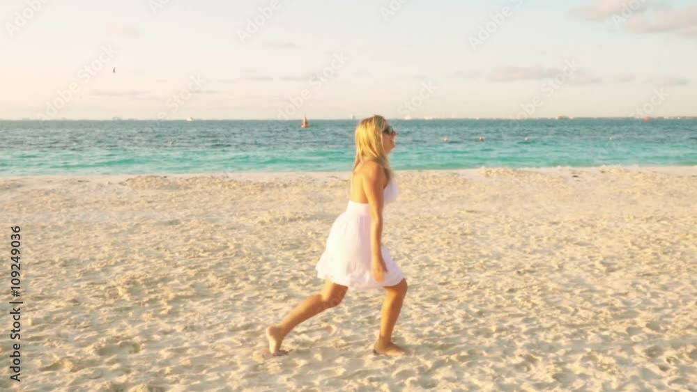happy woman in white dress jumping and running on the beach arms raised to the sky happy woman in white dress jumping and running on the beach arms raised to the sky