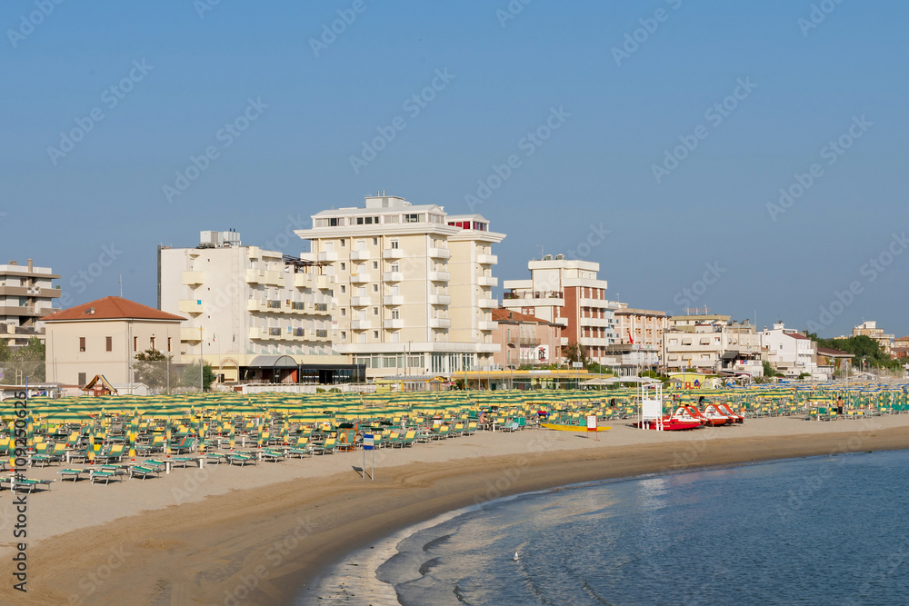 Rimini beach equipped with sun beds and umbrellas in the early morning summer