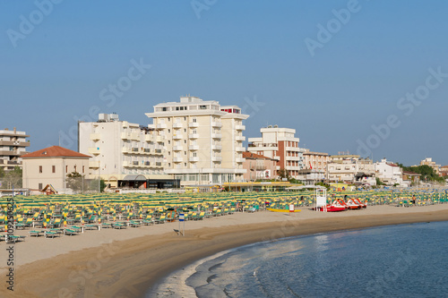 Rimini beach equipped with sun beds and umbrellas in the early morning summer