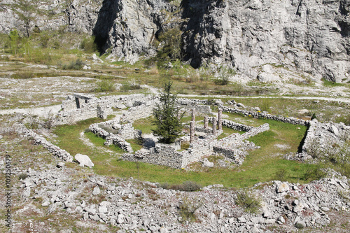 old stone walls under rocks in former limestone quarry Kamenarka near Stramberk, Czech Republic  photo