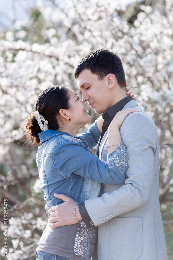Attractive couple in blossoming park Attractive couple in blossoming park