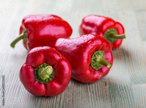 Fresh organic bell peppers on a wooden board