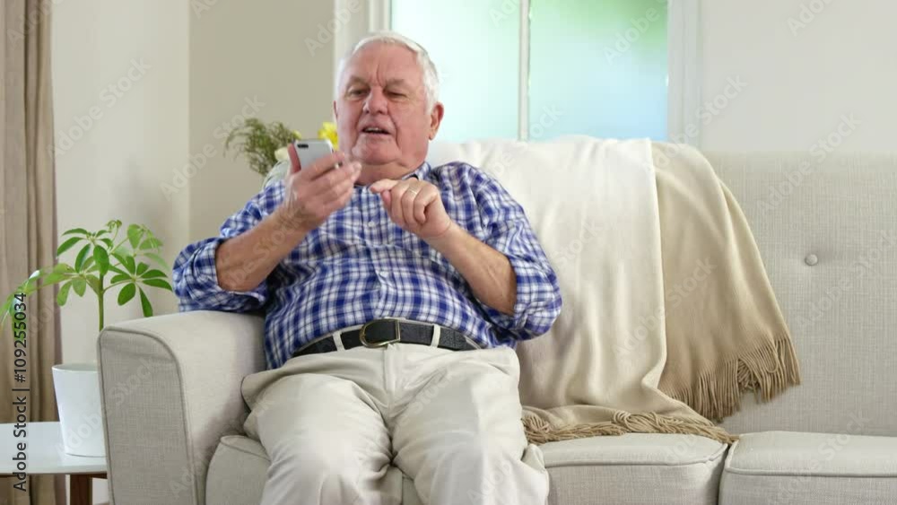 Senior man on the phone on couch Senior man on the phone on couch