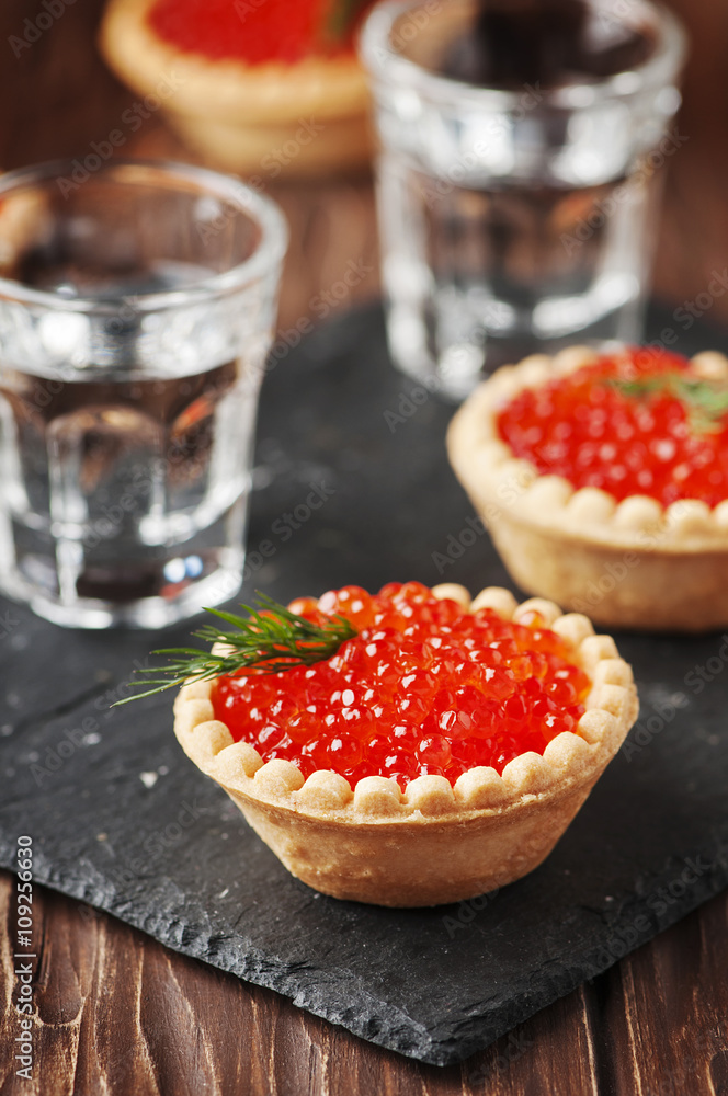 Traditional russian red caviare on the wooden table Traditional russian red caviare on the wooden table