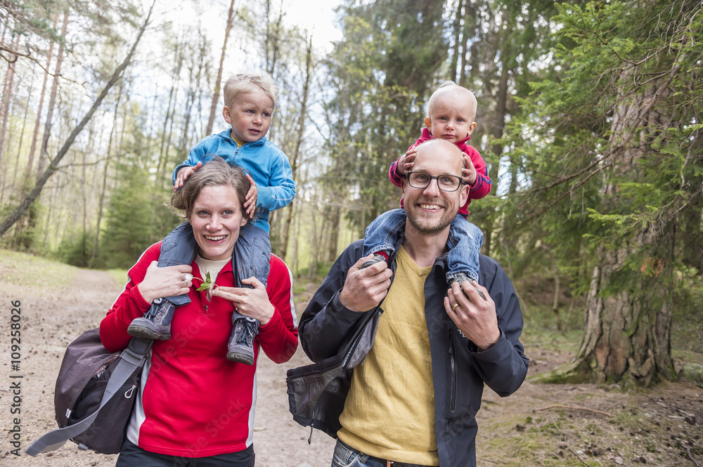 Smiling family walking in forest Smiling family walking in forest