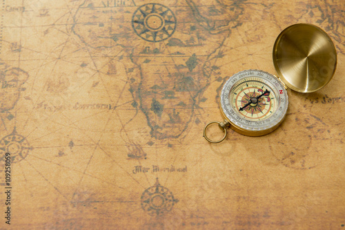 old compass on vintage map