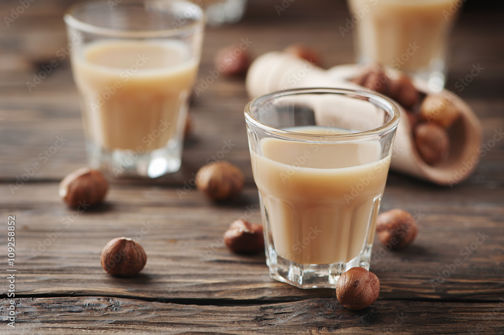 Italian hazelnut liqueur on the wooden table Italian hazelnut liqueur on the wooden table