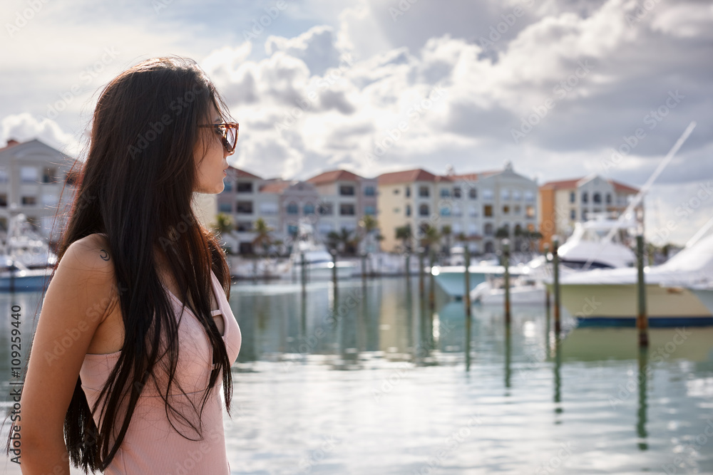 Young woman in a yacht harbour
