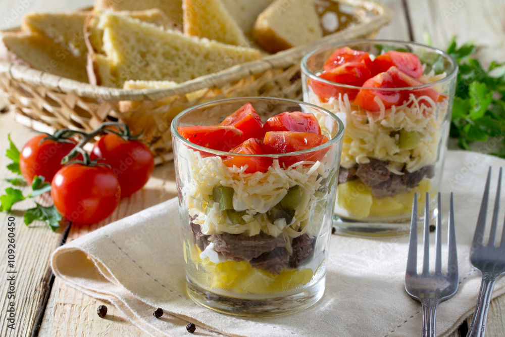 Salad with meat and vegetables on a wooden table, selective focu Salad with meat and vegetables on a wooden table, selective focu