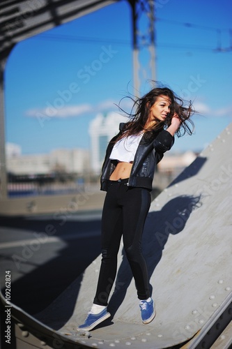 beautiful sexy girl with long hair standing and romantically looks. Her hair fluttering in the wind.