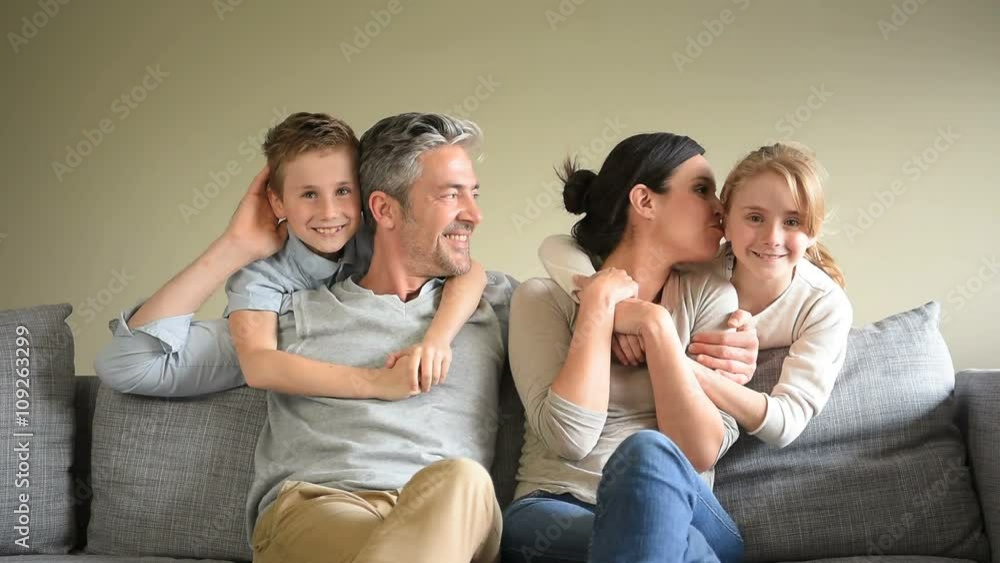 Portrait of happy family sitting in sofa Portrait of happy family sitting in sofa