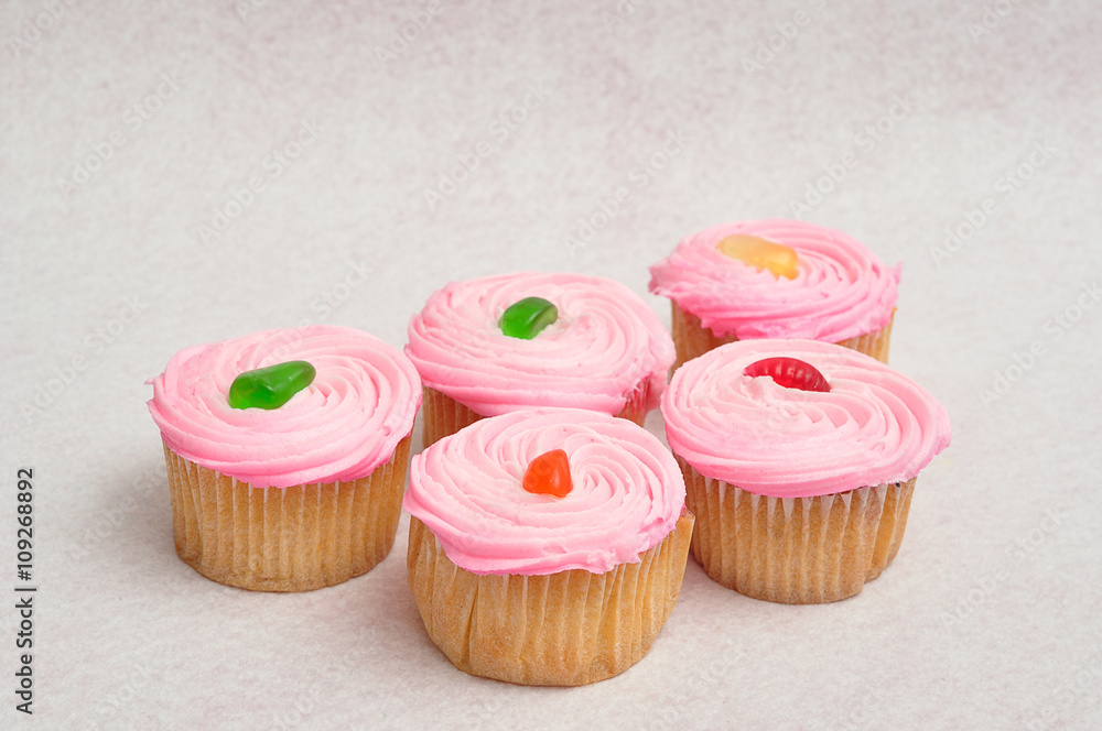 Pink cupcakes displayed on a white background Pink cupcakes displayed on a white background