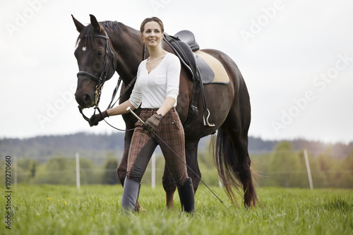 Woman walking with horse