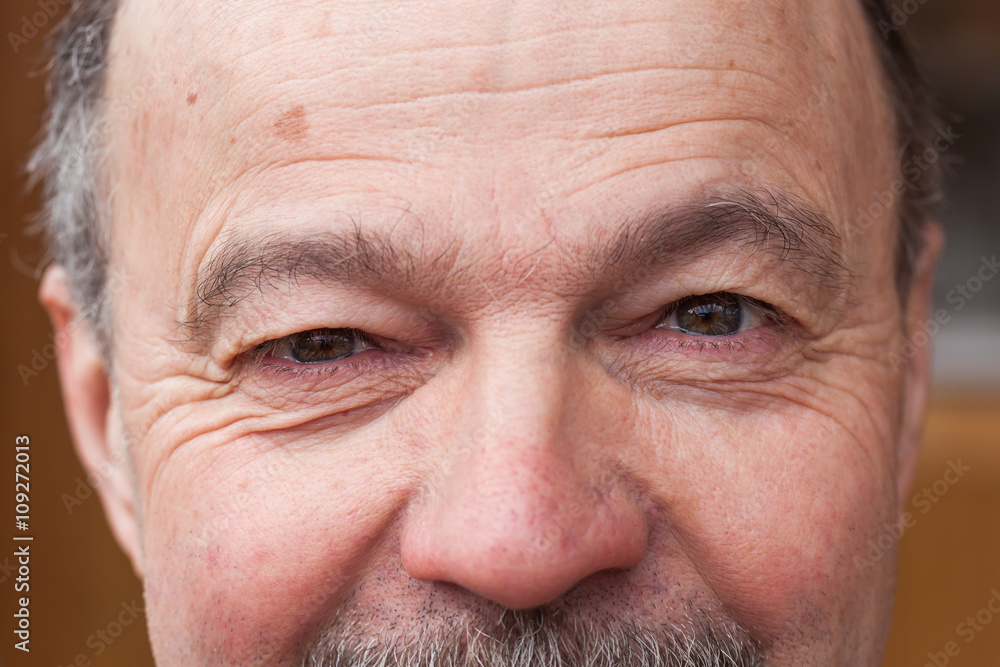 Pensioner looking intently ahead. Tired eyes from life Pensioner looking intently ahead. Tired eyes from life