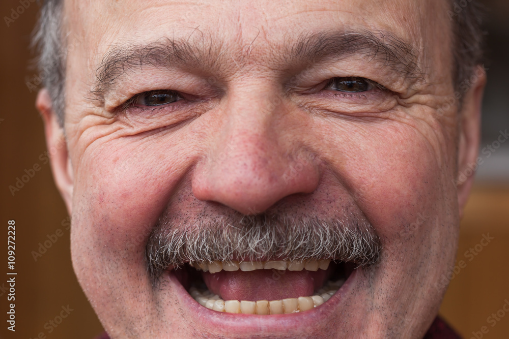 Elderly man laughs from ear to ear. joy of the good news