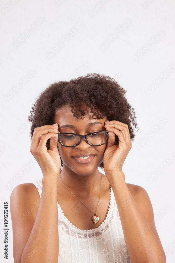 Woman arranging her glasses and smiling Woman arranging her glasses and smiling