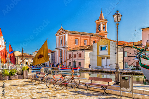 Church, boats and bycicles on Canal Port