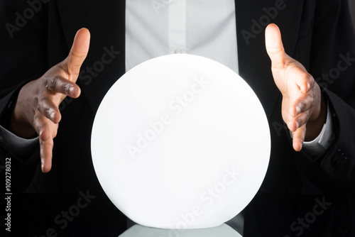 Businessperson Predicting Future With Crystal Ball photo