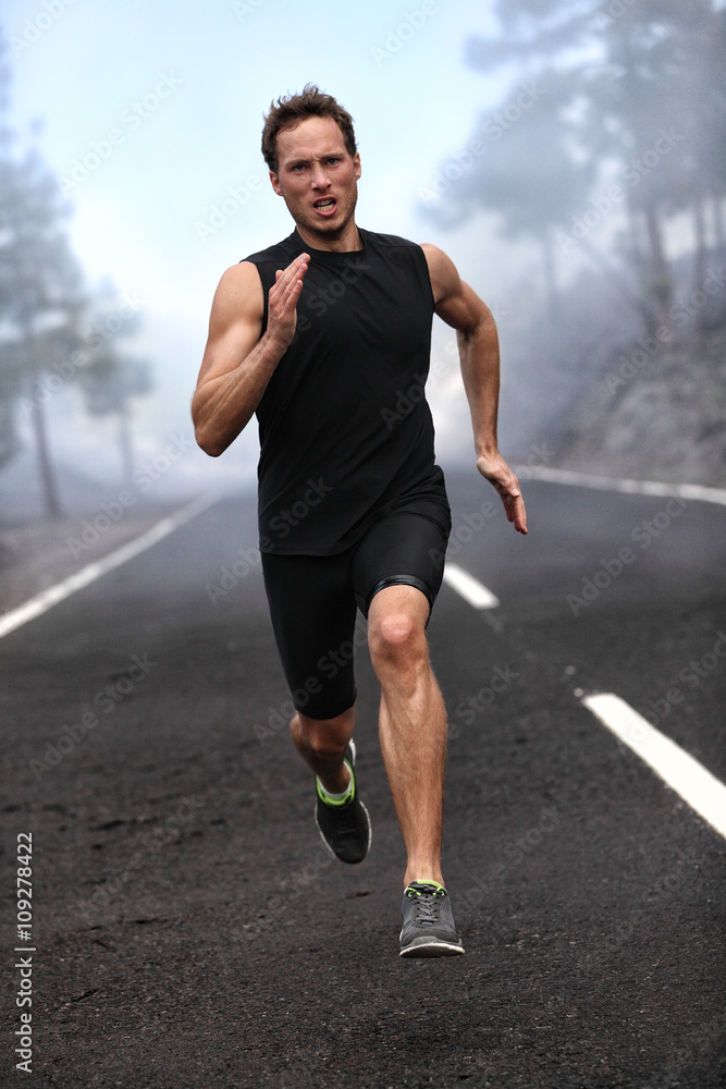 Running runner man sprinting workout on mountain road. Jogging male fitness model working out training for marathon on forest road in amazing nature landscape. Running runner man sprinting workout on mountain road. Jogging male fitness model working out training for marathon on forest road in amazing nature landscape.