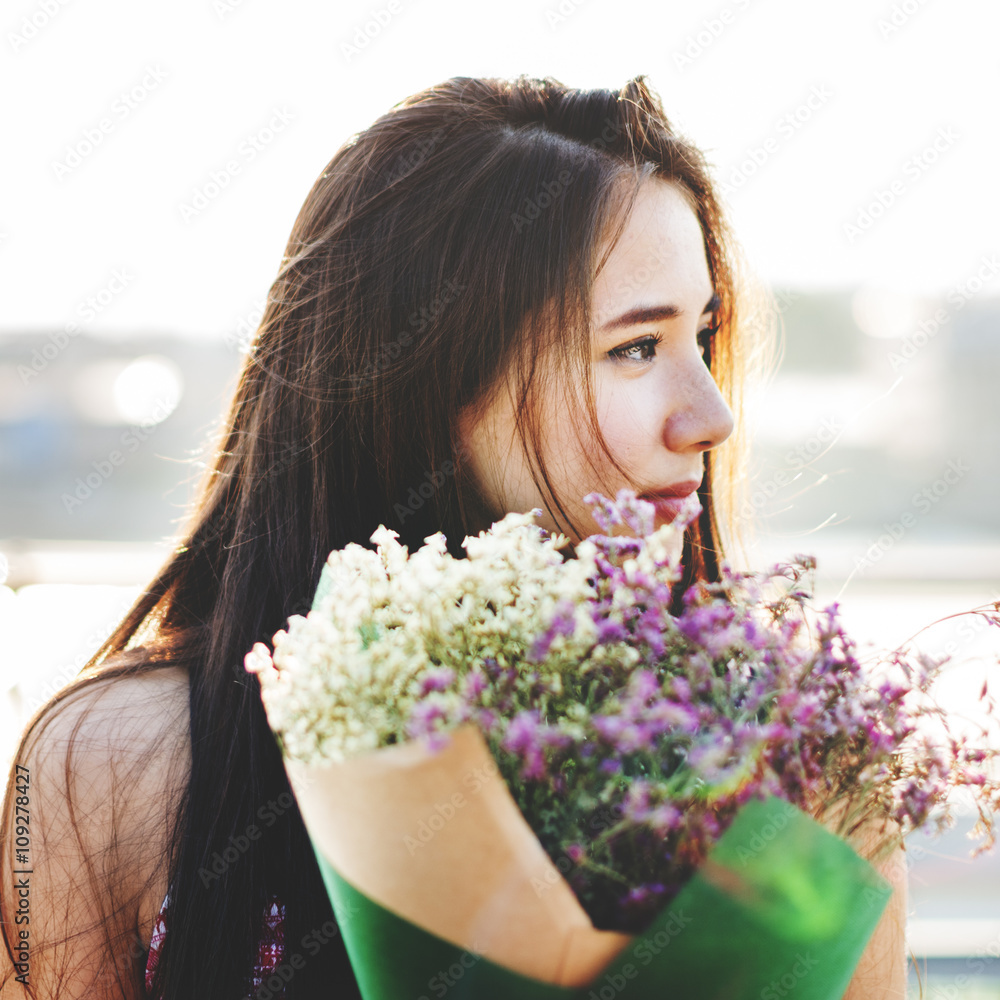 Naklejka premium Young Happy Woman Holding Flowers Concept