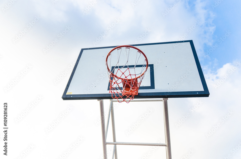 Basketball hoop on blue sky and clouds