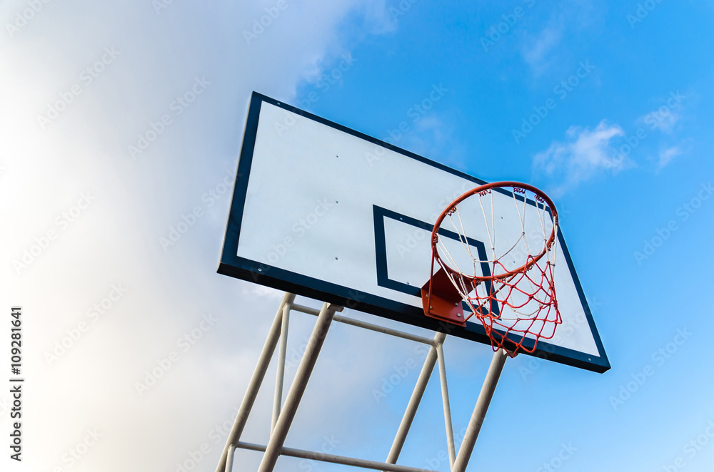 Basketball hoop on blue sky and clouds