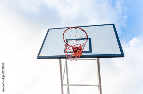 Basketball hoop on blue sky and clouds © Zenzeta