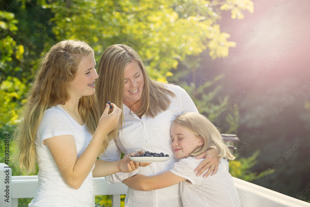 Fototapeta premium Family enjoying the moment outdoors on deck during summer time