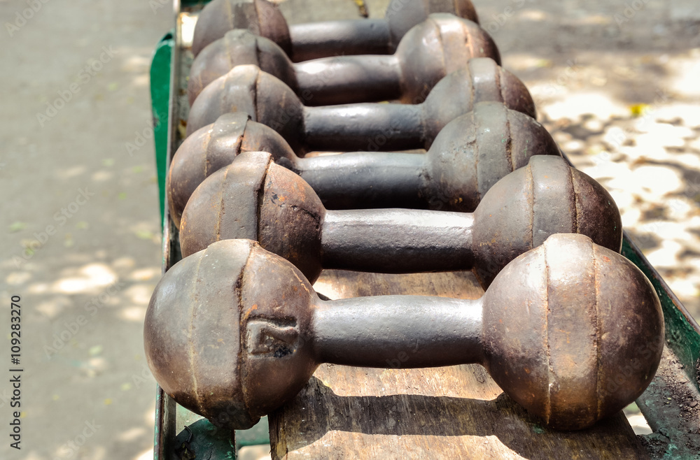 Selective focus of old dumbbell. Outdoor view dumbbell rust weights Stock Photo Adobe Stock