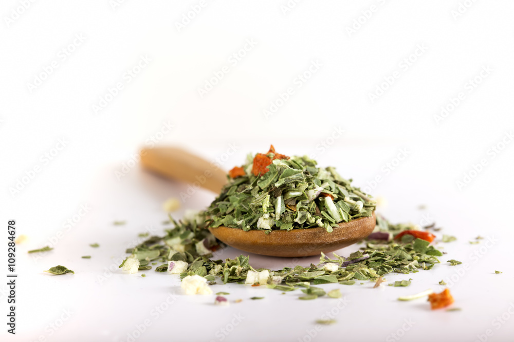 Spoon with dried oregano and thyme, basil and vegetables Spoon with dried oregano and thyme, basil and vegetables