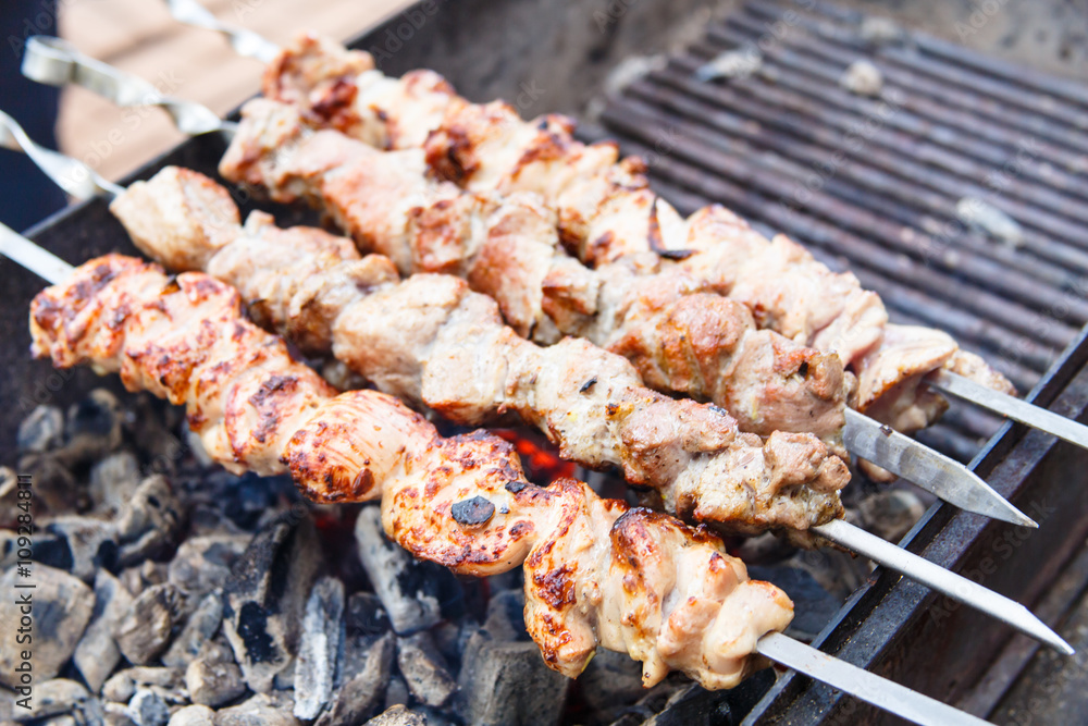.Shish kebab roasting on the coals.