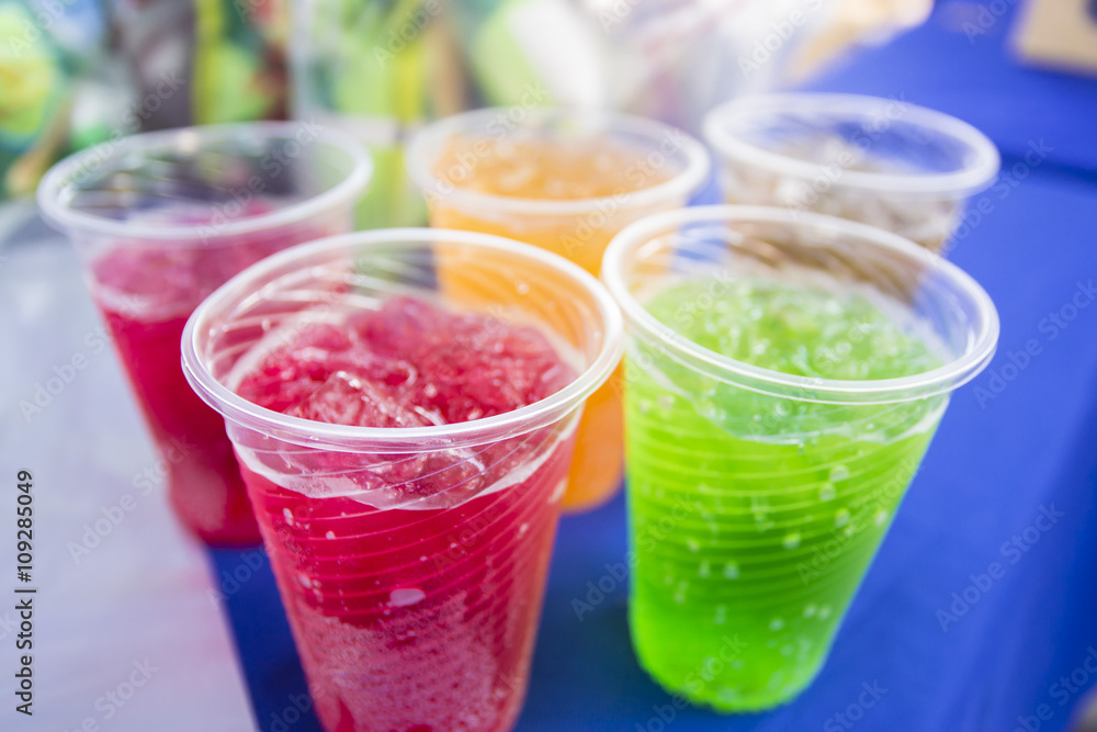 Soft drinks in plastic cups. Refreshing drink Soft drinks in plastic cups. Refreshing drink