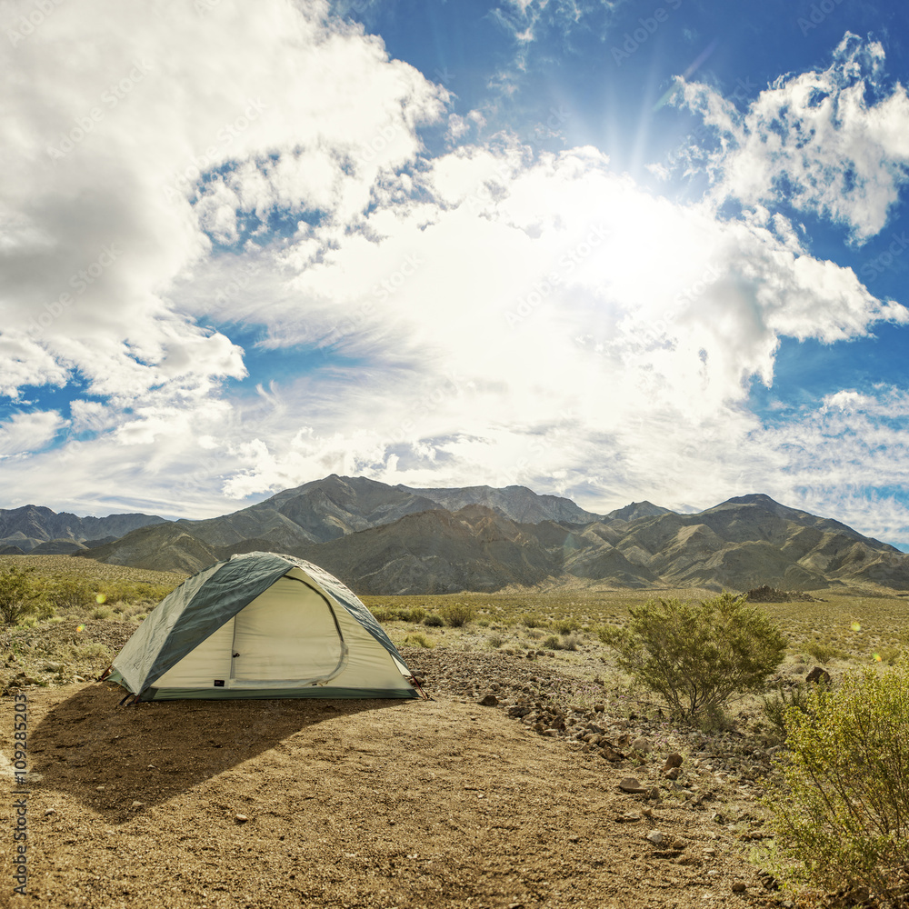 Camping tent in a wild remote nature park area of desert and mountain trails