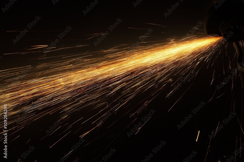 Glowing flow of steel metal spark particles shine in the dark background - obrazy, fototapety, plakaty 